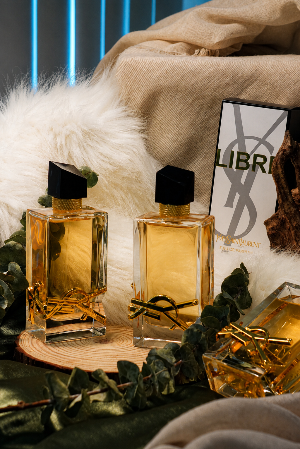YSL Libre fragrance bottles arranged with fabric and eucalyptus